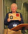 Bob Trevathan displays the appreciation plaque for Ed McCloskey.